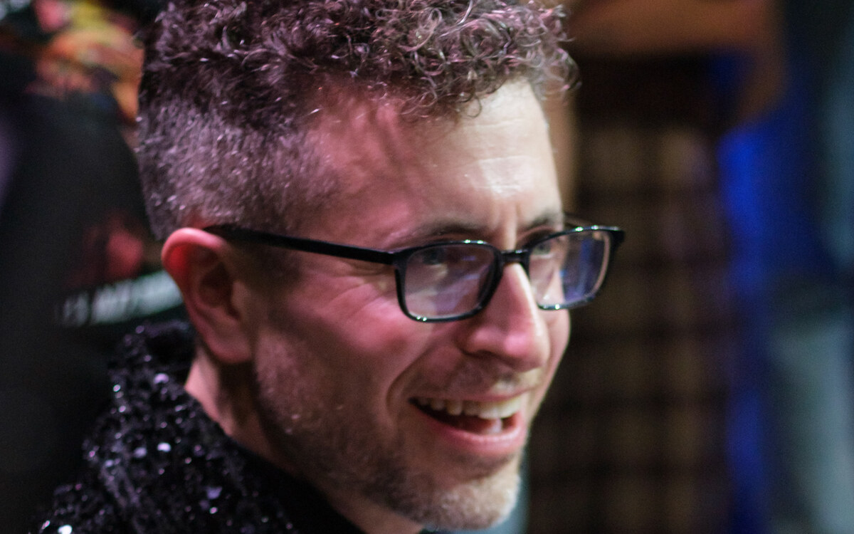 Greg Spero smiling at the keys